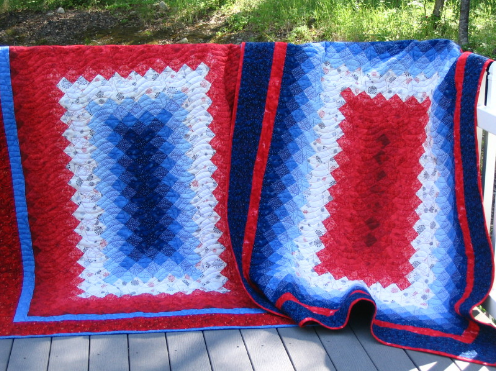 2 fraternal twin quilts made of small red white and blue squares